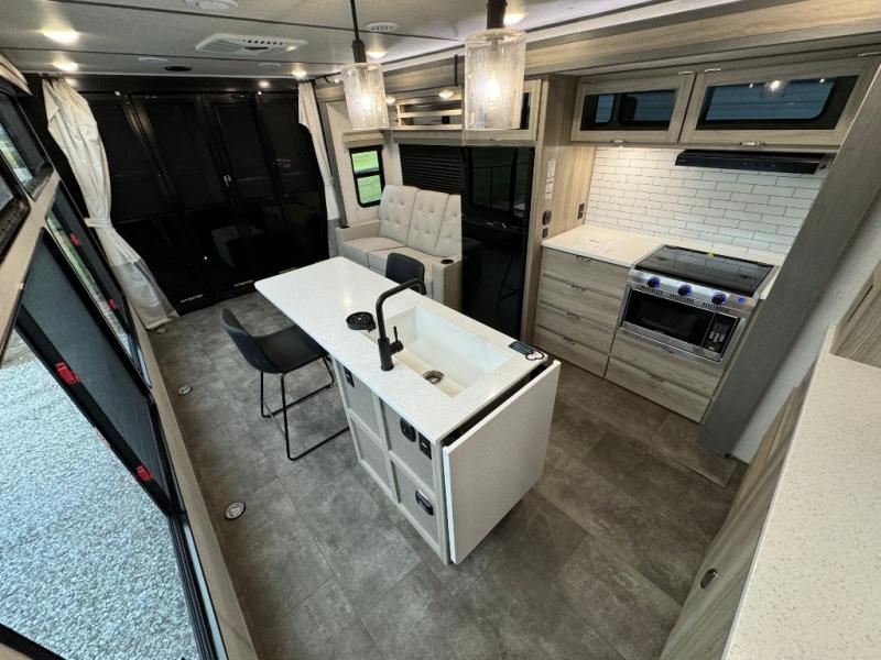 Forest River RV Wildwood FSX 30VCVIEW toy hauler travel trailer interior garage view with a kitchen island and kitchen and seating area